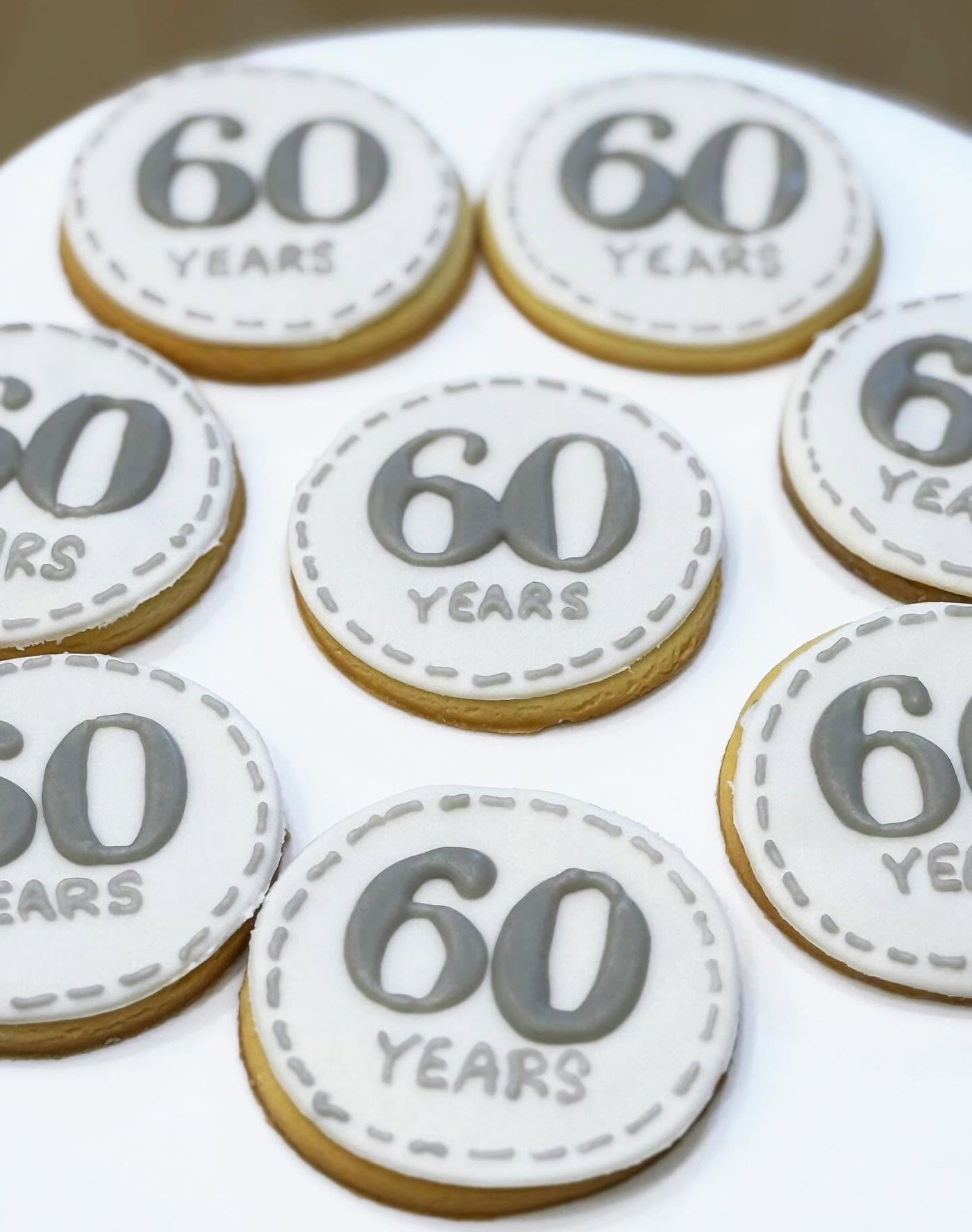 Elegant anniversary cookies with gold script