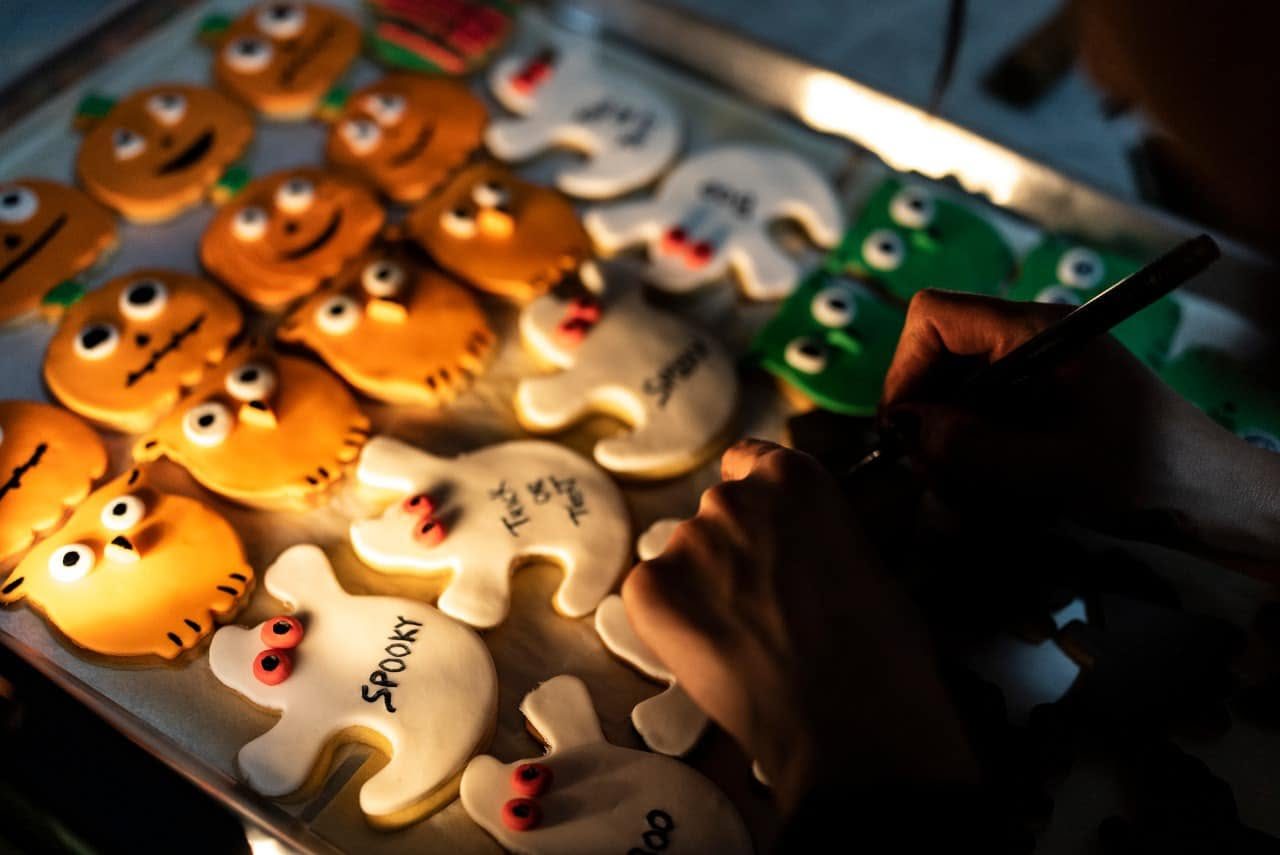Hand decorating Halloween cookies
